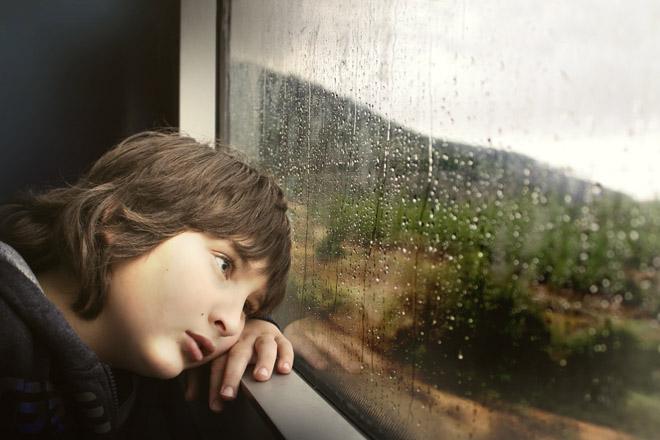 boy looking out of window